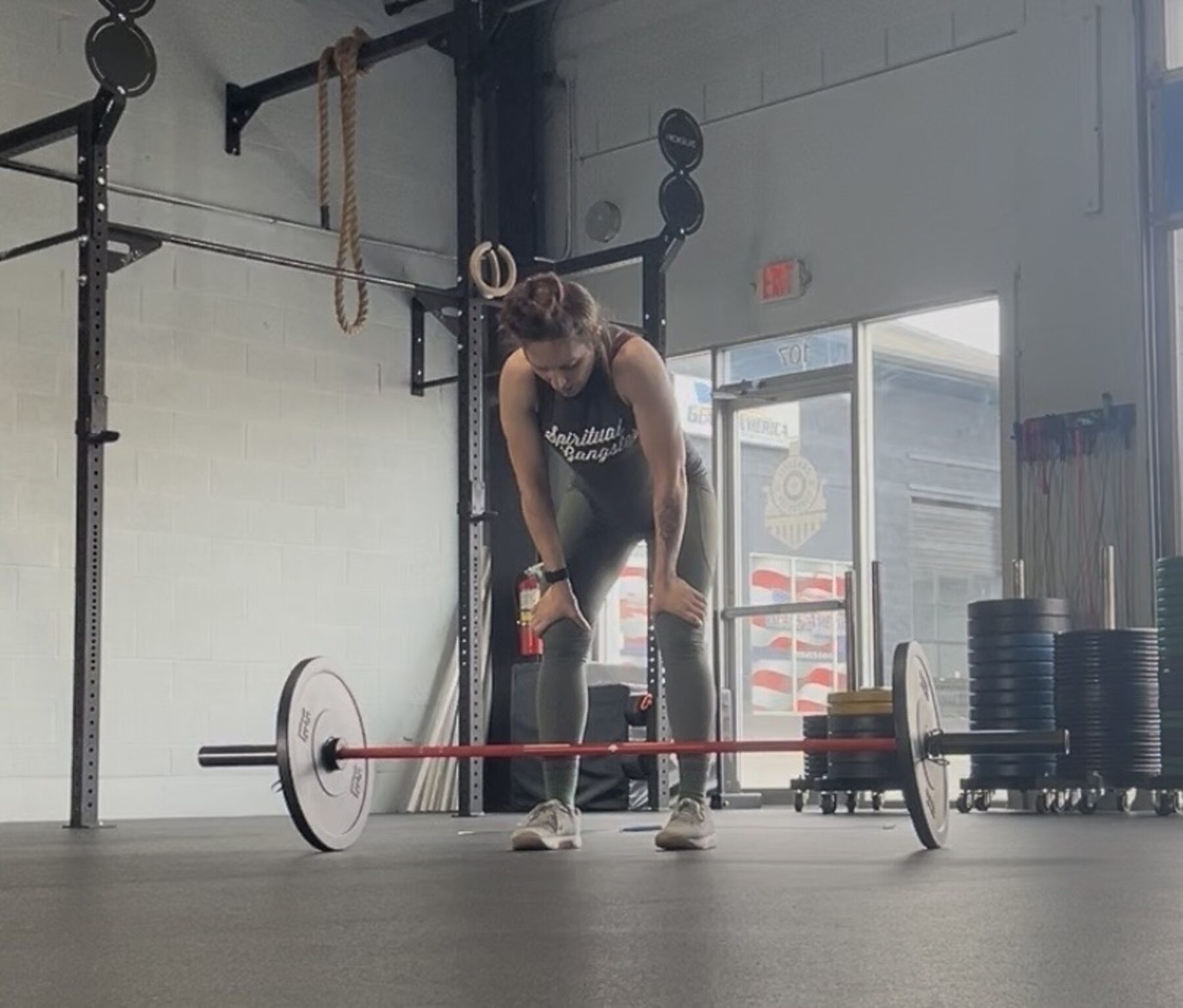 Amanda catching her breath over a loaded barbell